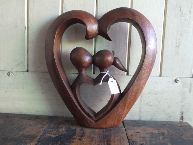Lovers inside heart wood carving